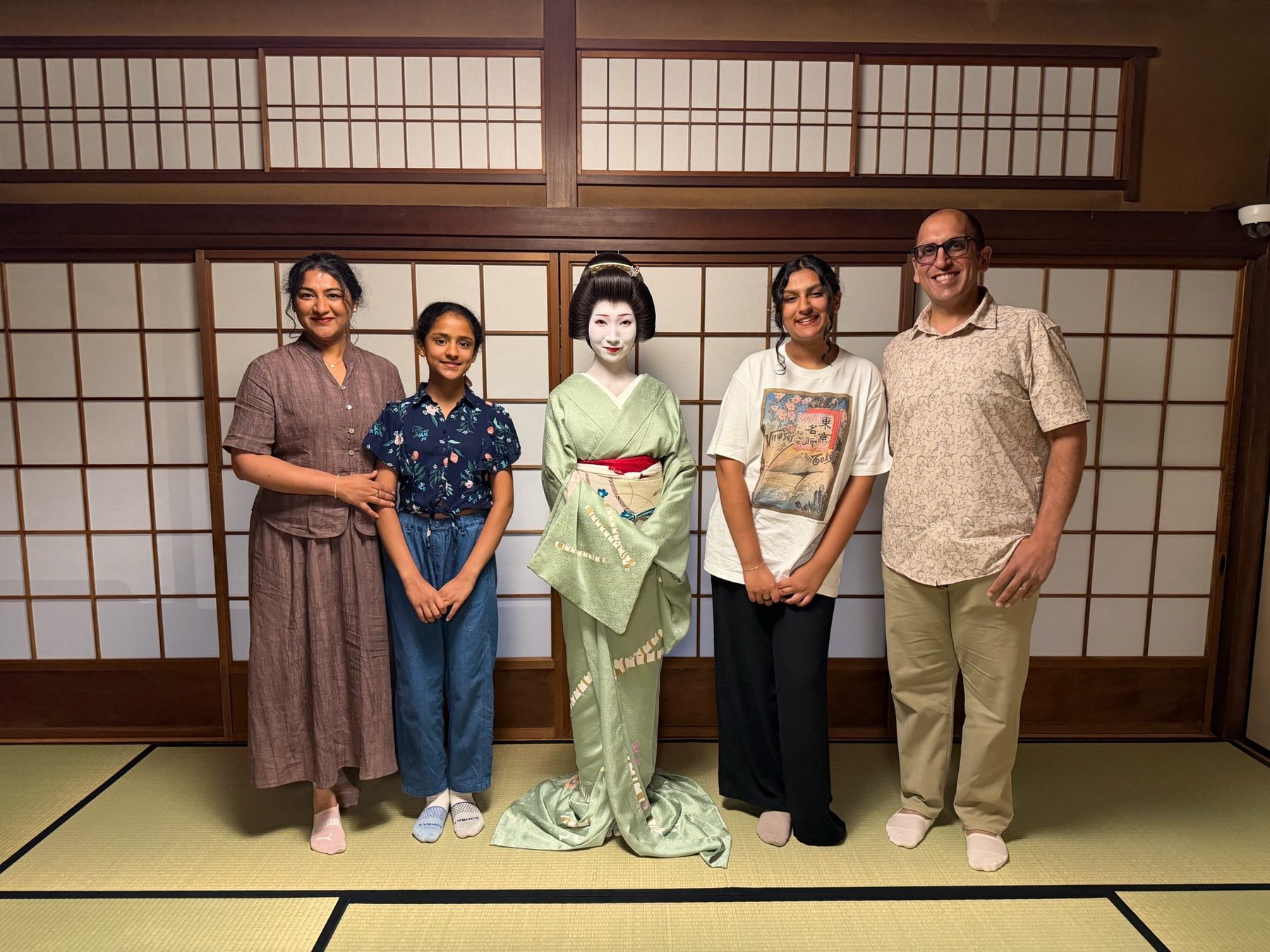 The family with a maiko in a tatami room in Kyoto