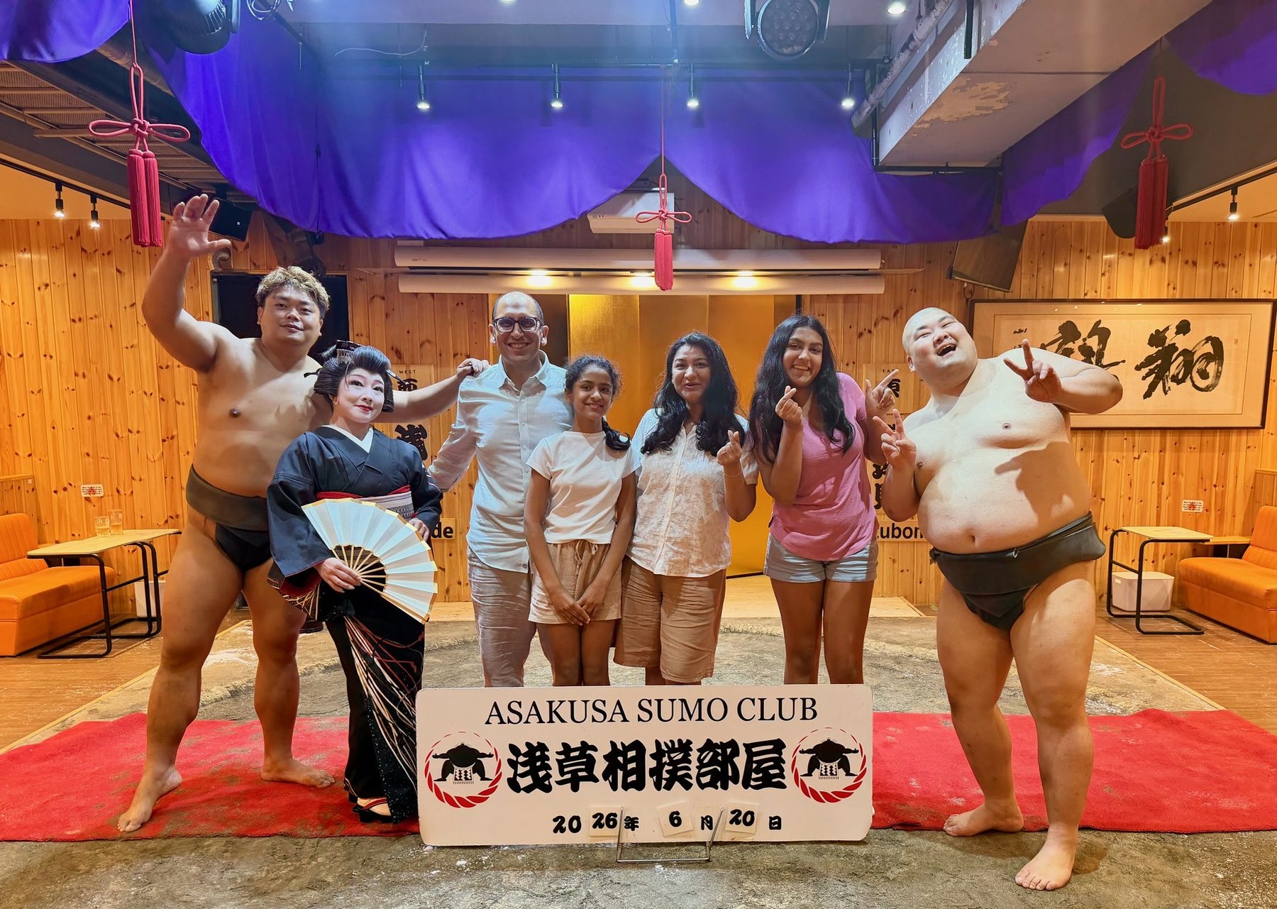 The family with sumo wrestlers at Asakusa Sumo Club