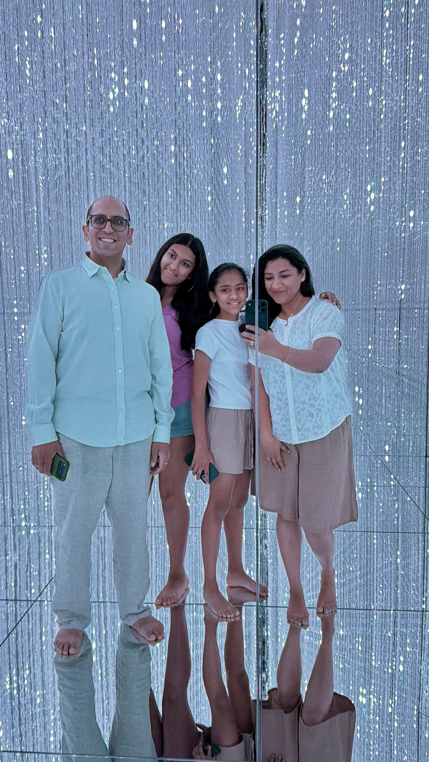 The family in a mirrored crystal room at teamLab Planets